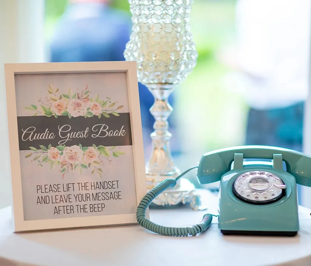 blue audio guestbook with a sign letting people know how to leave a message