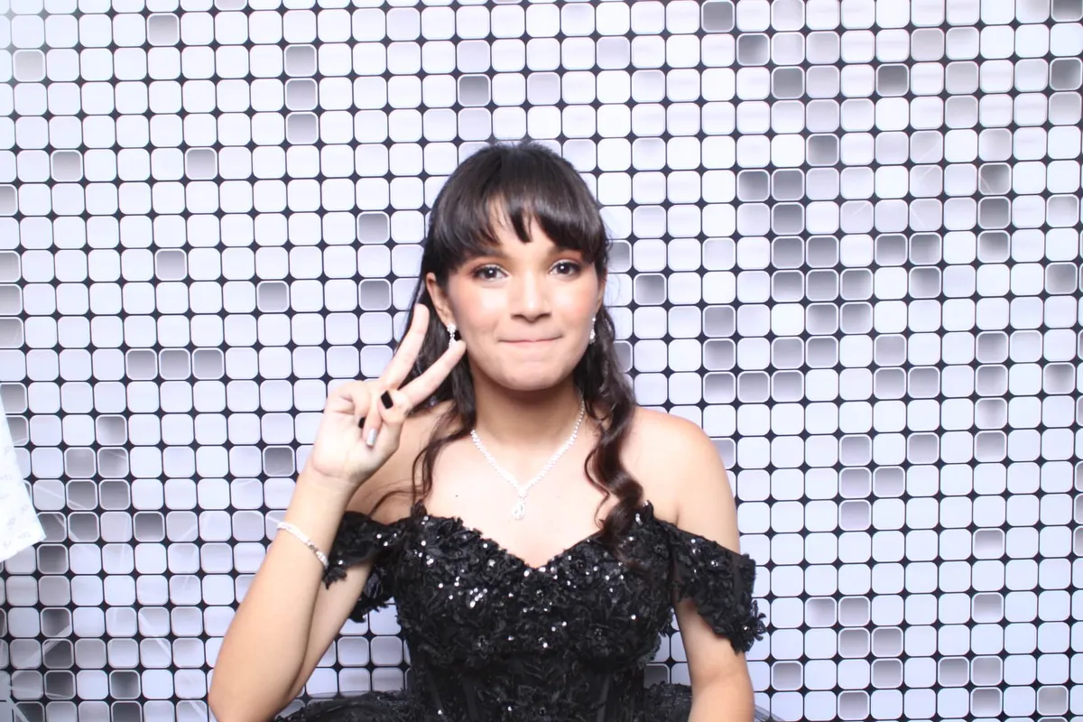 Quince posing in front of a silver backdrop