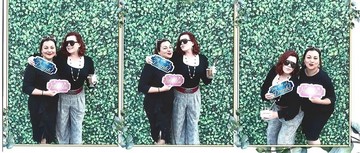 Joyful couple capturing memories in a vibrant photobooth, sharing laughter and smiles as they pose for candid and spontaneous shots at the event