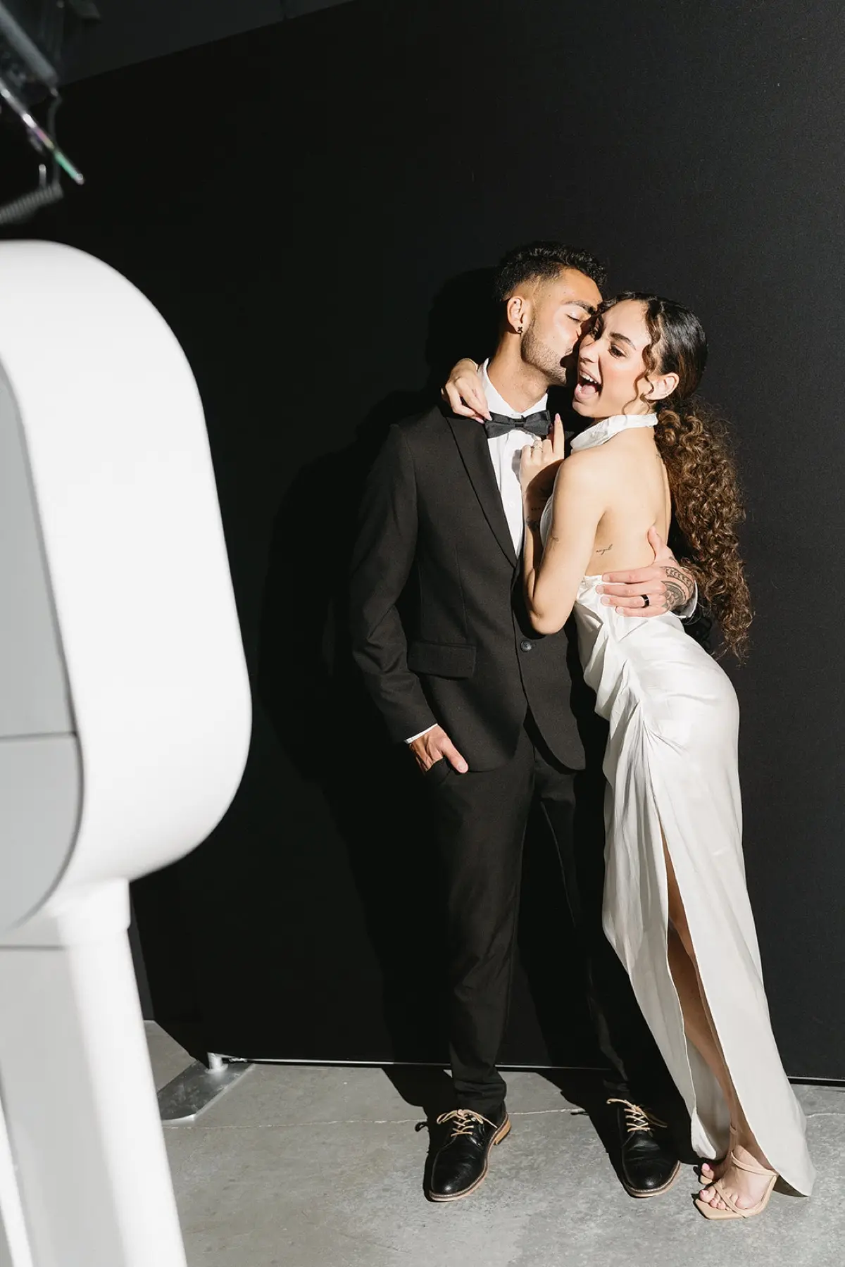 Late-night photo booth party scene with joyful guests in Los Angeles