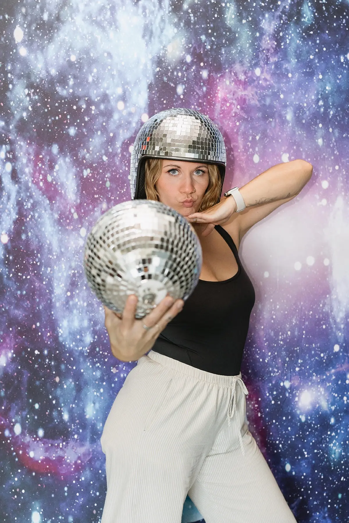 Guests posing in a space galaxy themed photo booth with professional studio lighting