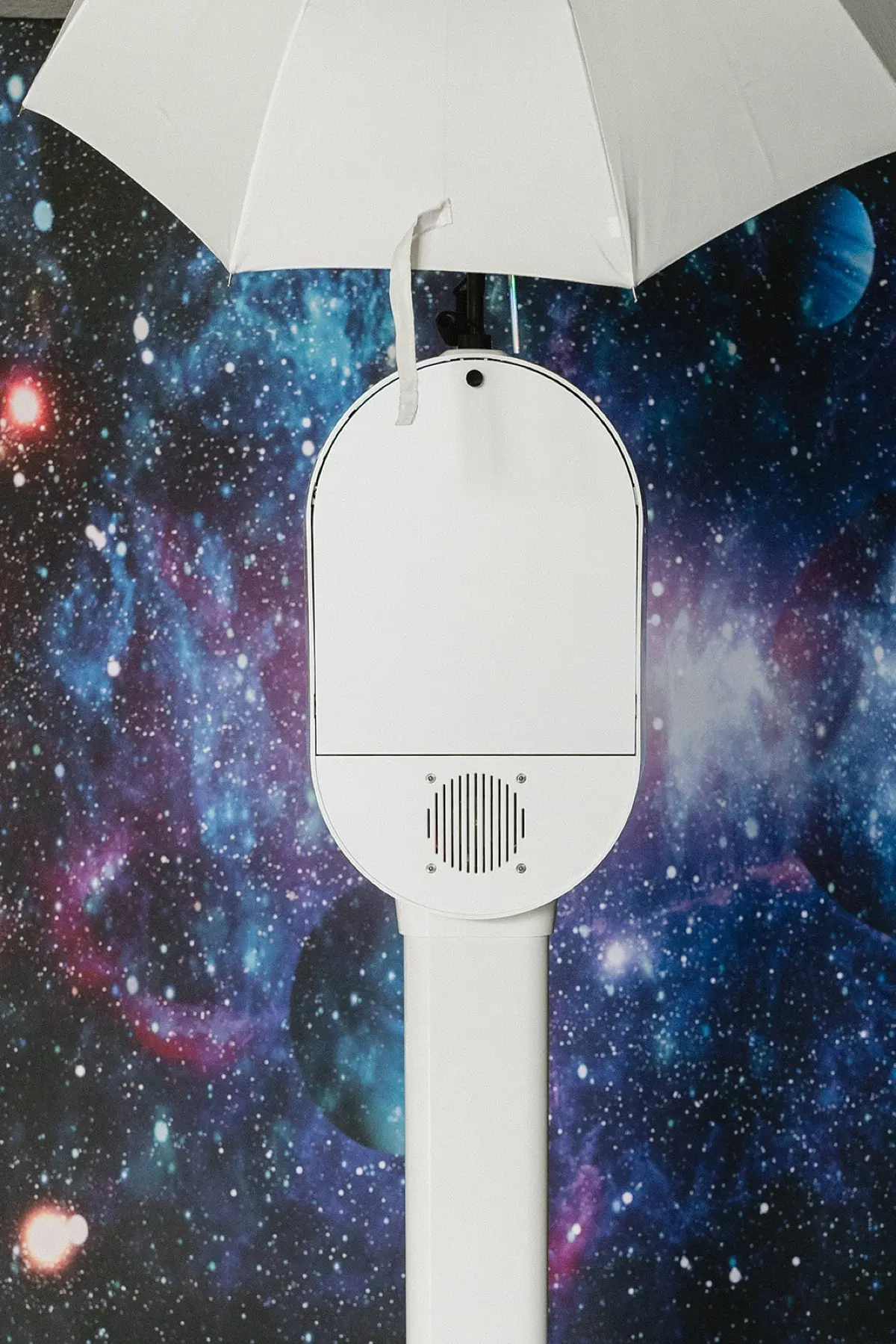 Space galaxy themed photo booth with dynamic lighting at a corporate event