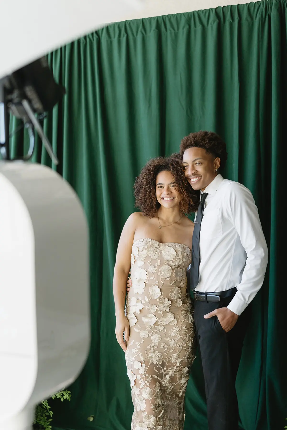 Velour floral photo booth setup with botanical green accents in Los Angeles