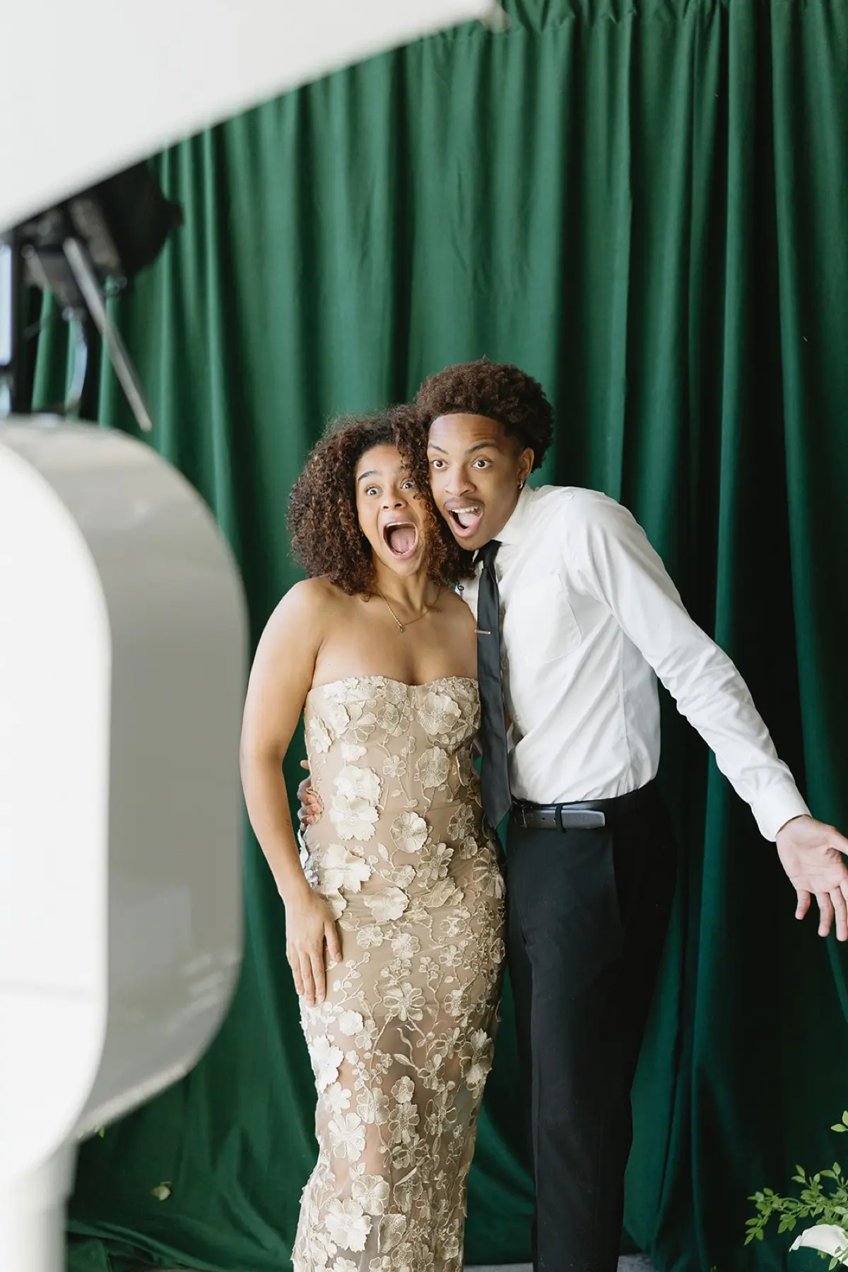 Velour floral photo booth with natural green botanical styling at a Los Angeles celebration