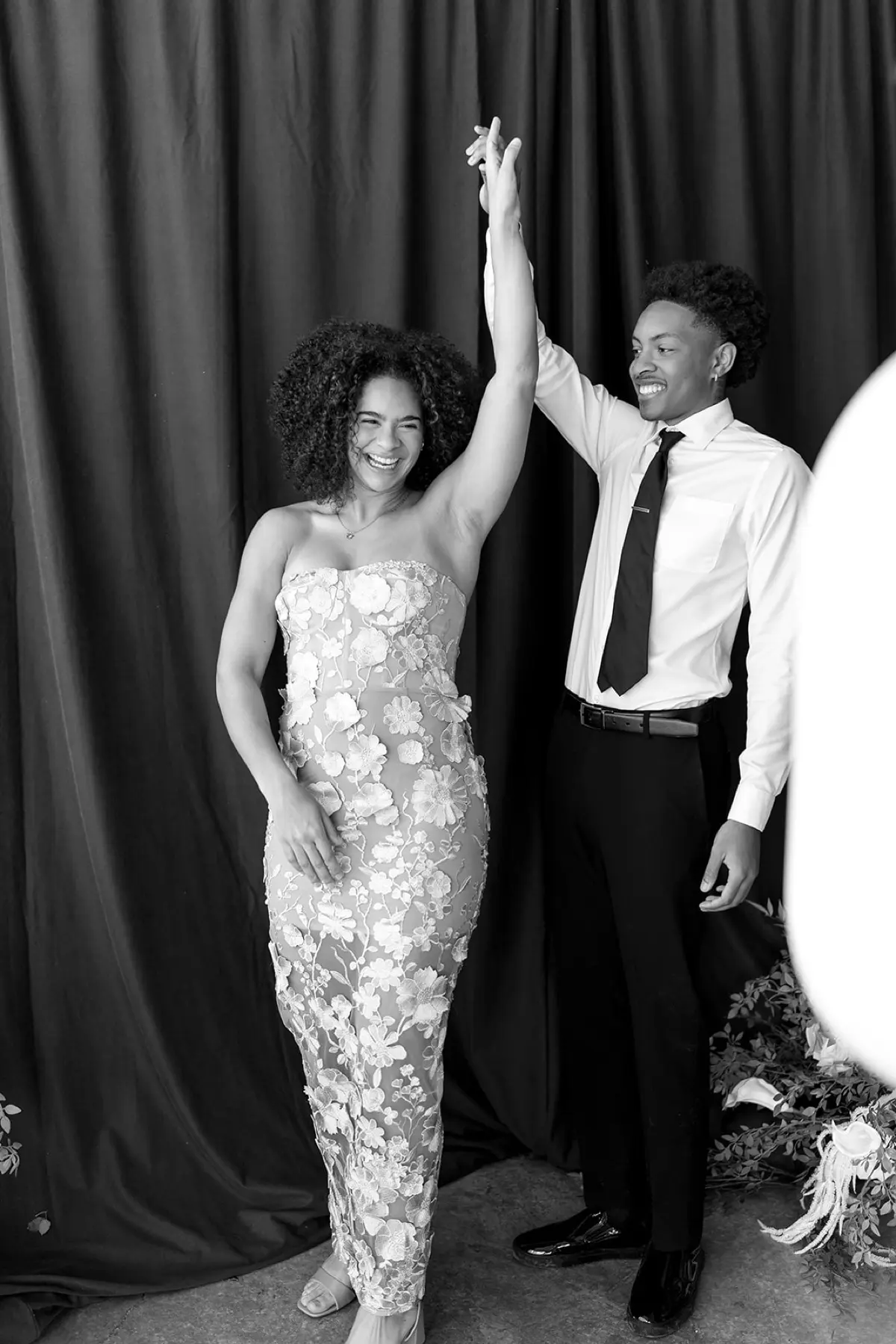 Velour floral green photo booth roaming setup capturing candid moments at an event