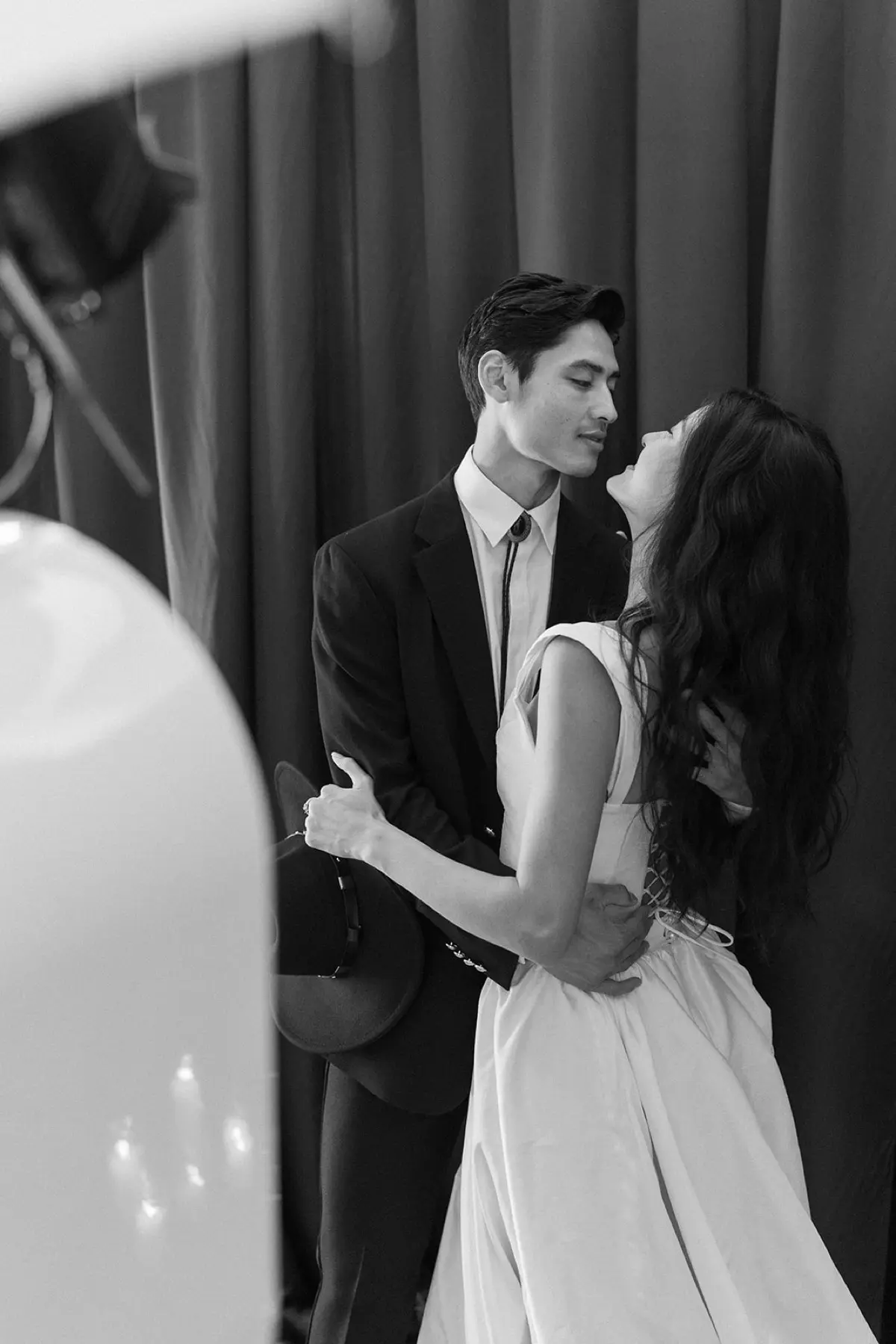 Western-themed photo booth with rustic brown curtain backdrop complementing industrial venue aesthetics